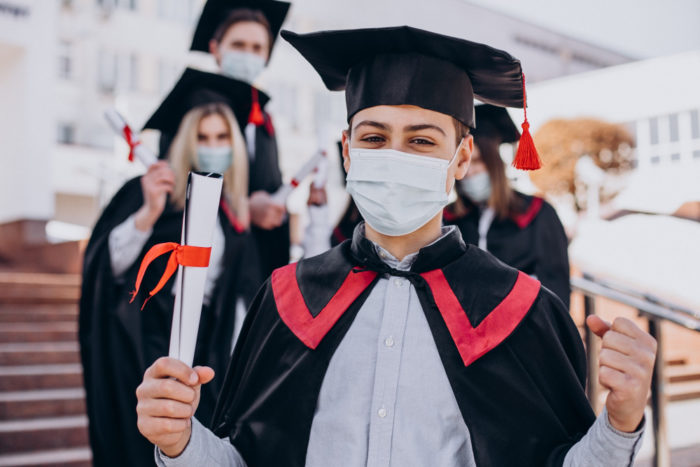 group students celebrating graduation together wearing face masks 700x467 - Dapatkan Beasiswa ke Malaysia dengan 4 Tips Berikut Ini!